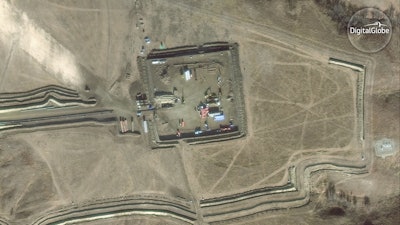 In this Nov. 25, 2016 satellite image taken by DigitalGlobe, the construction site of the the Dakota Access pipeline is seen near Cannon Ball, N.D. (DigitalGlobe via AP)