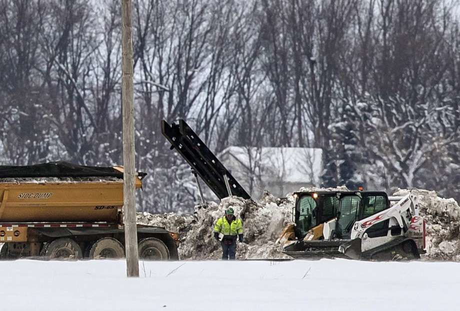 Crews work Thursday, Jan. 26, 2017, to clean up a diesel fuel spill after a pipeline owned by Magellan Midstream Partners broke at about 8 a.m. near Hanlontown, Iowa on Wednesday. (Chris Zoeller /Globe-Gazette via AP)