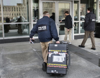Federal law enforcement agents enter the headquarters of Caterpillar, Inc., in Peoria, Ill., on Thursday, March 2, 2017, after a search warrant was executed at three Caterpillar facilities in central Illinois. (David Zalaznik/Journal Star via AP)