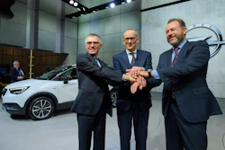 Carlos Tavares, left, CEO of PSA Peugeot Citroen, Karl-Thomas Neumann, center, CEO of Opel Group and President of General Motors Dan Ammann, right, shake hands during the press day at the 87th Geneva International Motor Show in Geneva, Switzerland, Tuesday, March 7, 2017. The Motor Show will open its gates to the public from March 9 to 19. (Martial Trezzini/Keystone via AP)