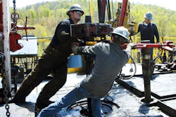 Workers move a section of well casting at a natural gas well site in Pennsylvania. Energy expert Daniel Yergin says that in addition to trucks and traffic, natural gas production can bring jobs and economic growth to gas-rich areas. (Ralph Wilson/AP Photo)
