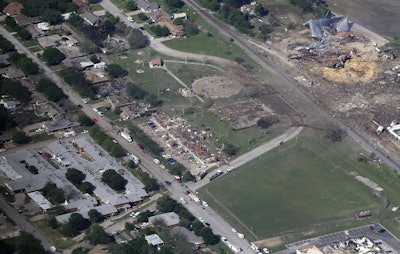 In this April 18, 2013 aerial file photo, the remains of a nursing home, left, apartment complex, center, and fertilizer plant, right, destroyed by an explosion at a fertilizer plant in West, Texas. (AP Photo/Tony Gutierrez, File)