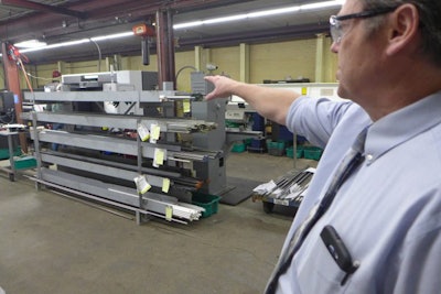 Daniel Bickel, production and operations manager at Nercon, points to a stock rack. Following the precepts of lean operations, Nercon has pruned its racks to carry only the stock needed at each location. Photo: David Tenenbaum