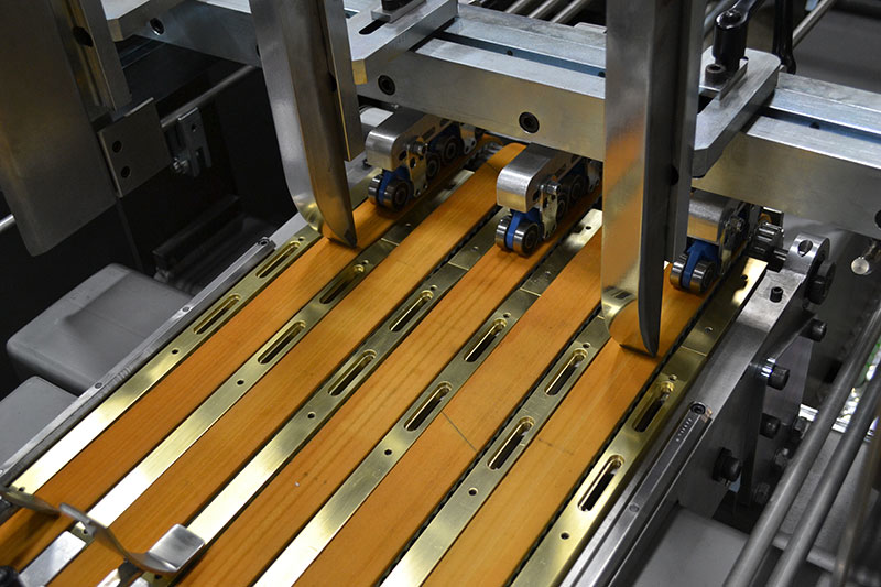 Pulse feeding, which, unlike conventional friction feeders, allows the blanks to sit flat.