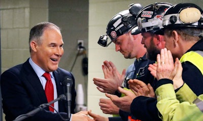 In this April 13, 2017 file photo Environmental Protection Agency (EPA) Administrator Scott Pruitt, left, shakes hands with coal miners during a visit to Consol Pennsylvania Coal Company's Harvey Mine in Sycamore, Pa. The Trump administration wants to trash Obama-era rules to limit water pollution from coal-fired power plants. Pruitt announced the change this week. Administrator Scott Pruitt sent a letter to a coalition of energy companies that lobbied against the 2015 water pollution rule. (AP Photo/Gene J. Puskar, File)