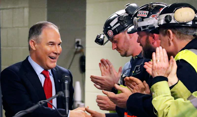 In this April 13, 2017 file photo Environmental Protection Agency (EPA) Administrator Scott Pruitt, left, shakes hands with coal miners during a visit to Consol Pennsylvania Coal Company's Harvey Mine in Sycamore, Pa. The Trump administration wants to trash Obama-era rules to limit water pollution from coal-fired power plants. Pruitt announced the change this week. Administrator Scott Pruitt sent a letter to a coalition of energy companies that lobbied against the 2015 water pollution rule. (AP Photo/Gene J. Puskar, File)