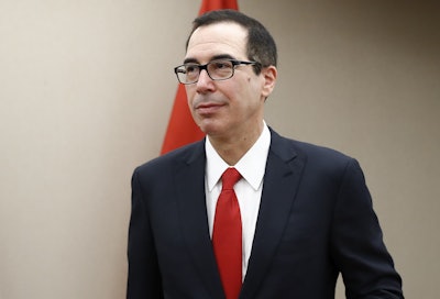 Treasury Secretary Steven Mnuchin arrives for a meeting, Friday, April 21, 2017, at the 2017 World Bank Group Spring Meetings in Washington. Mnuchin said in a brief statement that the administration 'will not be issuing waivers to U.S. companies, including Exxon, authorizing drilling prohibited by current Russian sanctions.' (AP Photo/Carolyn Kaster)