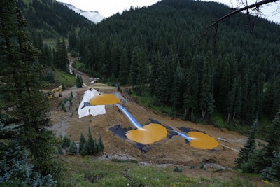 n this Aug. 12, 2015 photo, mine wastewater flows through a series of retention ponds built to contain and filter out heavy metals and chemicals from the Gold King Mine chemical accident in the spillway about 1/4 mile downstream from the mine, outside Silverton, Colo. Farmers, business owners and residents initially said they suffered $1.2 billion in lost income, property damage and personal injuries from the 2015 spill at the Gold King Mine. The total now appears to be about $420 million after attorneys for a handful of New Mexico property owners slashed their claims by $780 million. (AP Photo/Brennan Linsley)