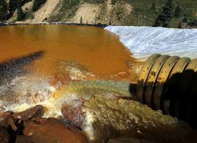 In this Aug. 14, 2015, file photo, water flows through a series of sediment retention ponds built to reduce heavy metal and chemical contaminants from the Gold King Mine wastewater accident, in the spillway downstream from the mine, outside Silverton, Colo. Farmers, business owners and residents initially said they suffered $1.2 billion in lost income, property damage and personal injuries from the 2015 spill at the Gold King Mine. The total now appears to be about $420 million after attorneys for a handful of New Mexico property owners slashed their claims by $780 million. (AP Photo/Brennan Linsley, File)