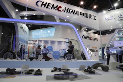 In this Sept. 21, 2016 file photo, visitors tour the exhibition booth of ChemChina, also known as China National Chemical Corp., during the China International Chemical Industry Fair in Shanghai, China. U.S. regulators have agreed to the Chinese conglomerate’s proposed $43 billion acquisition of Swiss agribusiness giant Syngenta on condition it sells some businesses to satisfy anti-monopoly objections. The Federal Trade Commission’s announcement on Tuesday, April 4, 2017, follows approval last year by European regulators of the purchase by state-owned ChemChina. It would be China’s biggest foreign acquisition to date. (AP Photo/Andy Wong, File)