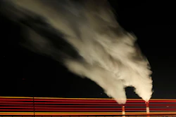In this Jan. 19, 2012 file photo, smoke rises in this time exposure image from the stacks of the La Cygne Generating Station coal-fired power plant in La Cygne, Kan. The Environmental Protection Agency on Tuesday, April 18, 2017, asked a federal appeals court in Washington to postpone consideration of 2012 rules requiring energy companies to cut emissions of toxic chemicals. The agency said in a court filing it wants to review the restrictions, which were set to kick in next month. (AP Photo/Charlie Riedel, File)