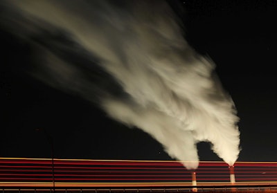In this Jan. 19, 2012 file photo, smoke rises in this time exposure image from the stacks of the La Cygne Generating Station coal-fired power plant in La Cygne, Kan. The Environmental Protection Agency on Tuesday, April 18, 2017, asked a federal appeals court in Washington to postpone consideration of 2012 rules requiring energy companies to cut emissions of toxic chemicals. The agency said in a court filing it wants to review the restrictions, which were set to kick in next month. (AP Photo/Charlie Riedel, File)