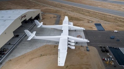 In this May 31, 2017 photo provided by Stratolaunch Systems Corp., the newly built Stratolaunch aircraft is moved out of its hangar for the first time in Mojave, Calif. The aircraft will undergo ground tests in preparation for flights in which the aircraft will launch rockets from high altitude. (Stratolaunch Systems Corp. via AP)
