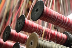This Thursday, March 23, 2017, photo, shows spools of thread at Bally Ribbon Mills in Bally, Pa. On Thursday, June 15, 2017, the Federal Reserve reports on U.S. industrial production for May. (AP Photo/Matt Rourke)