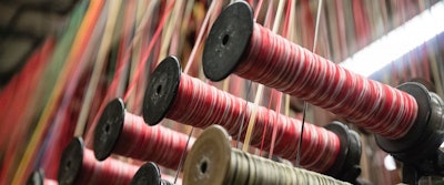 This Thursday, March 23, 2017, photo, shows spools of thread at Bally Ribbon Mills in Bally, Pa. On Thursday, June 15, 2017, the Federal Reserve reports on U.S. industrial production for May. (AP Photo/Matt Rourke)