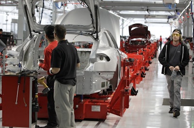 Assembly workers put together a Tesla Model S at the Tesla factory in Fremont. (AP Photo/Paul Sakuma)