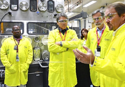 In this May 10, 2017, file photo, U.S. Secretary of Energy Rick Perry, second from left, accompanied by Laboratory Director Charlie McMillan, second from right, learns about capabilities at the Los Alamos National Laboratory's Plutonium Facility, from Jeff Yarbrough, right, Los Alamos Associate Director for Plutonium Science and Manufacturing in Los Alamos, N.M. Criticism of the safety record at one of the nation's top federal laboratories is intensifying as work at Los Alamos National Laboratory ramps up to produce a key component for the nation's nuclear weapons cache. (Los Alamos National Laboratory via AP, file)