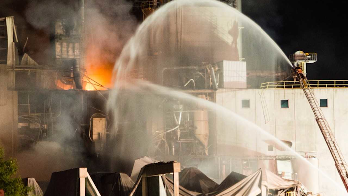 This Thursday, June 1, 2017, photo provided by Jeff Lange shows firefighters at the scene following an explosion and fire at the Didion Milling plant in Cambria, Wis. Recovery crews searched a mountain of debris on Thursday following a fatal explosion late Wednesday at the corn mill plant, which injured about a dozen people and leveled parts of the sprawling facility in southern Wisconsin, authorities said. (Jeff Lange via AP)