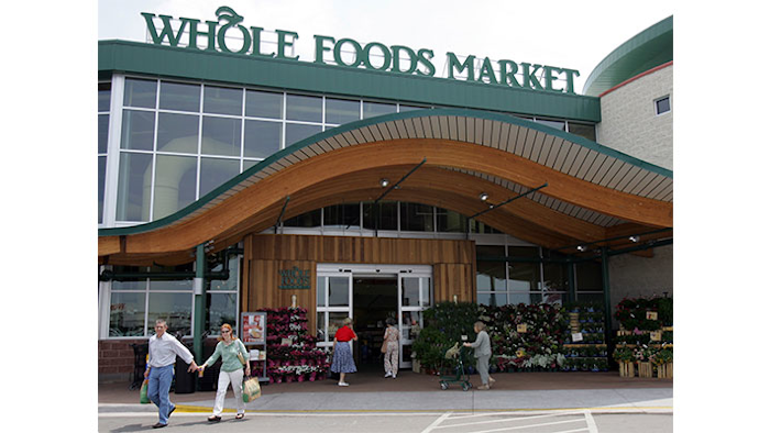 FILE - In this May 9, 2007 file photo, customers are seen outside a Whole Foods Market in Dallas. Online juggernaut Amazon announced Friday, June 16, 2017, that it is buying Whole Foods in a deal valued at about $13.7 billion, including debt. Amazon.com Inc. will pay $42 per share of Whole Foods Market Inc. AP Photo/LM Otero