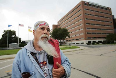 In this Wednesday, June 28, 2017 photo, Mike Carlin, who has worked at the Oscar Mayer plant for 23 years, talks about the plant closure after finishing up his shift at the Kraft Oscar Mayer headquarters and plant in Madison, Wis. The last cold cuts are rolling off the line at Oscar Mayer in Madison, ending nearly 100 years of production at the plant on Thursday. (Amber Arnold/Wisconsin State Journal via AP)