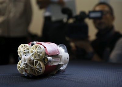 Newly developed robot mockup for underwater investigation for a Fukushima's damaged reactor, is displayed at a Toshiba Corp. test facility in Yokosuka near Tokyo Thursday, June 15, 2017. The robot, which is nicknamed ' Little sunfish', co-developed by the debt-strapped Japanese nuclear and electronics company and the International Research Institute for Nuclear Decommissioning, is ready for deployment this summer at the badly-damaged Unit 3 primary containment vessel to assess its damage and locate parts of melted fuel, believed to be submerged under highly contaminated water. (AP Photo/Shuji Kajiyama)
