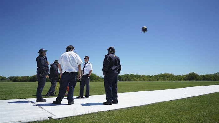 In this Monday, May 15, 2017, photo, an airship crew watches as a Goodyear airship prepares to land in Akron, Ohio. Goodyear airship pilots are getting retrained to fly new models after Goodyear deflated the last of its 45-year-old iconic blimps in March. (AP Photo/Dake Kang)