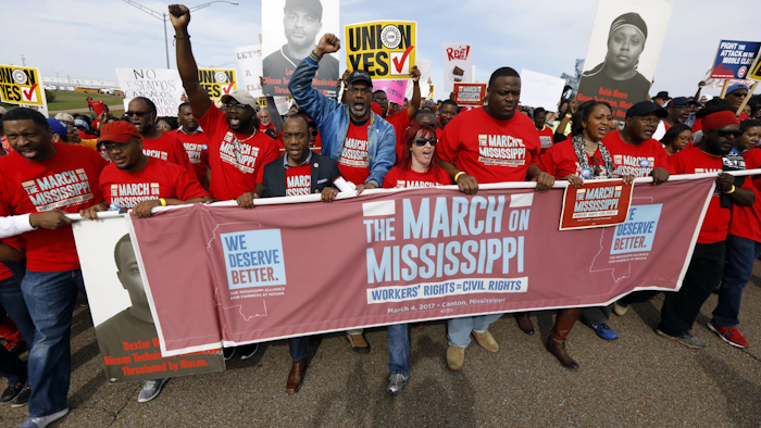 In this March 4, 2017, file photo, thousands march to Nissan Motor Co.'s Canton, Miss., plant, following a pro-union rally. The United Auto Workers filed Monday, July 10, an election petition with the National Labor Relations Board, to force a unionization election at the plant following years-long pressure campaign to build support. (AP Photo/Rogelio V. Solis, File)