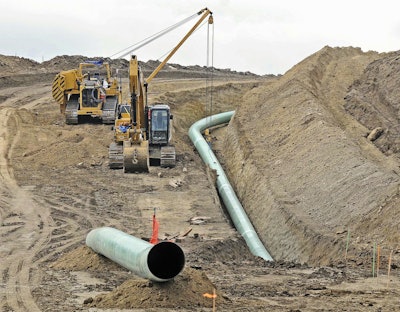 In this Oct. 5, 2016, file photo, heavy equipment works at a site where sections of the Dakota Access pipeline are being buried near the town of St. Anthony in Morton County, N.D. The Army Corps of Engineers says additional environmental review of the already-operating pipeline ordered by a judge in June 2017 is likely to take the rest of the year. (Tom Stromme/The Bismarck Tribune via AP, File)