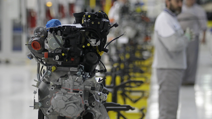 This file photo from Monday, April 16, 2012 shows a factory worker looking at an engine of a Fiat 500 L car in the assembly hall in the Fiat factory, in Kragujevac, some 100 kilometers (70 miles) south of Belgrade, Serbia. Hundreds of Fiat workers marched from the Serbian factory on Tuesday, July 18, 2017, to demand higher wages. (AP Photo/Darko Vojinovic, File)