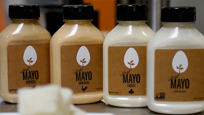 FILE - This Feb. 4, 2015, file photo, shows Hampton Creek Foods bottles of Just Mayo flavors at their office in San Francisco. Hellmann’s mayonnaise maker Unilever sued the maker of Just Mayo, a vegan spread, saying that mayonnaise is defined as having eggs under federal regulations. That lawsuit was dropped. Later, however, the maker of Just Mayo worked out an agreement with the Food and Drug Administration to keep its name, so long as it made some changes to its label to make clear the product does not contain eggs. (AP Photo/Jeff Chiu, File)