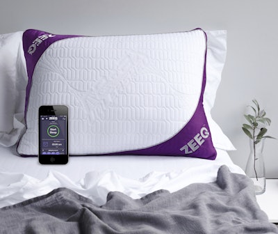 This photo provided by REM-Fit shows the Zeeq pillow, which monitors snoring and can gently vibrate to nudge someone into a different sleep position. The pillow can also play your favorite music, audio books and more without disturbing anyone next to you. A number of companies are adding more technology into their products, hoping to lure customers craving a better night’s sleep. (Jo Henderson/REM-Fit via AP)