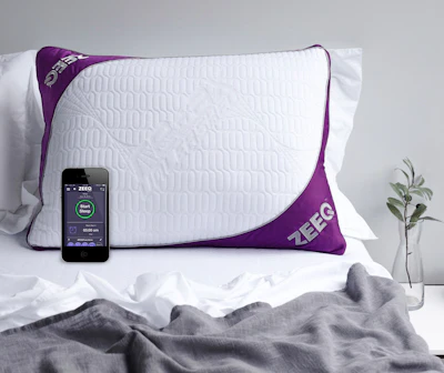 This photo provided by REM-Fit shows the Zeeq pillow, which monitors snoring and can gently vibrate to nudge someone into a different sleep position. The pillow can also play your favorite music, audio books and more without disturbing anyone next to you. A number of companies are adding more technology into their products, hoping to lure customers craving a better night’s sleep. (Jo Henderson/REM-Fit via AP)