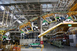 A line of Peugeot 206, containing its hatchback and sedan, is on the production line at the state-run Iran-Khodro automobile manufacturing plant near Tehran, Iran, Saturday, Oct. 11, 2014. (AP Photo)