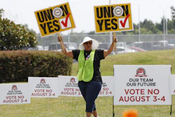 A UAW supporter sings as she tries to beat the hot sun outside an employee vehicle entrance at the Nissan vehicle assembly plant in Canton, Miss., Friday, Aug. 4, 2017. Union members set up informational lines outside employee entrances at the plant and greeted all shifts of workers arriving and leaving, reminding workers to vote for the union. The vote for union representation of line workers concludes Friday evening. (AP Photo/Rogelio V. Solis)