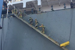 This photo courtesy of the Long Beach Fire Department shows firefighters boarding a ship responding to an hazmat incident in the Port of Long Beach, Calif., Sunday, Aug. 6, 2017. Long Beach firefighters treated 11 workers and one firefighter for exposure to some hazardous material fumes, at Pier G, where a flammable liquid leaked from a 6,000 gallon tank on a container vessel. Two persons have been taken to a hospital. (Brian Fisk/Long Beach Fire Department via AP)