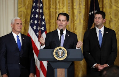 Wisconsin Gov. Scott Walker, accompanied by Vice President Mike Pence and House Speaker Paul Ryan, speaks in the East Room of the White House on July 26, 2017, after President Donald Trump announced that Foxconn would open a plant in the state. (Alex Brandon / AP)
