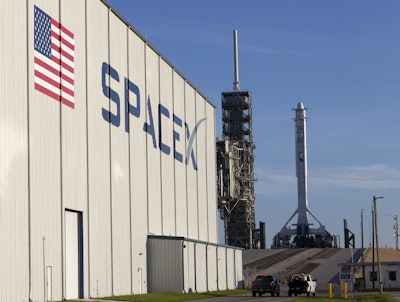In this photo provided by NASA, a SpaceX Falcon 9 rocket and Dragon spacecraft await liftoff from NASA Kennedy Space Center’s Launch Complex 39A in Cape Canaveral, Fla., on Monday, Aug. 14, 2017. SpaceX is about to launch a few tons of research to the International Space Station — plus ice cream. (Kim Shiflett/NASA via AP)