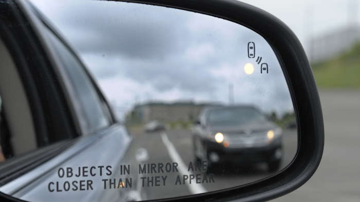 A side mirror warning signal in a Ford Taurus at an automobile testing area in Oxon Hill, Md. Safety systems to prevent cars from drifting into another lane or warn drivers of vehicles in their blind spots are beginning to live up to their potential to significantly reduce crashes, according to two studies released Wednesday, Aug. 23, 2017. (AP Photo/Susan Walsh, File)
