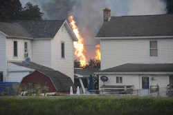 A fire burns at the site of a freight train derailment, Wednesday, Aug. 2, 2017, in Hyndman, Pa. A freight train carrying hazardous materials partly derailed early Wednesday, setting train cars and a garage on fire and prompting emergency officials to evacuate nearby residents. (Steve Bittner/The Cumberland Times-News via AP)