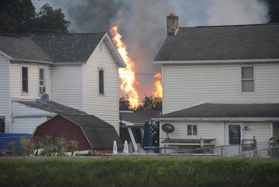 A fire burns at the site of a freight train derailment, Wednesday, Aug. 2, 2017, in Hyndman, Pa. A freight train carrying hazardous materials partly derailed early Wednesday, setting train cars and a garage on fire and prompting emergency officials to evacuate nearby residents. (Steve Bittner/The Cumberland Times-News via AP)
