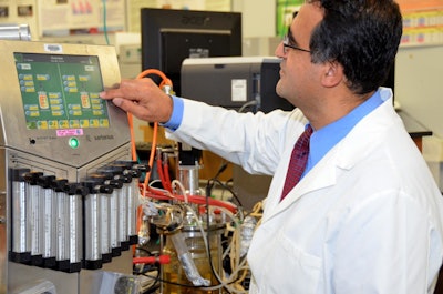 Researcher Ali Demirci adjusts a bioreactor in which potato waste is being used to produce bioethanol with a novel process that simultaneously employs mold and yeast to convert starch to sugar and sugar to ethanol. Credit: Dimerci Lab