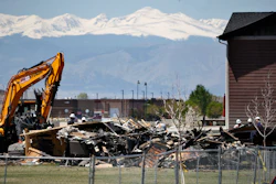 In this May 4, 2017, file photo, workers dismantle the charred remains of a house destroyed by an explosion triggered by natural gas in Firestone, Colo. The April 17, blast killed two people. Investigators blamed the explosion on gas leaking from a severed pipeline that was thought to have been abandoned but was still connected to a well. Colorado Gov. John Hickenlooper said Tuesday, Aug. 22, that the state is tightening regulations on oil and gas pipelines to reduce the chances of another such explosion. (AP Photo/Brennan Linsley, File)