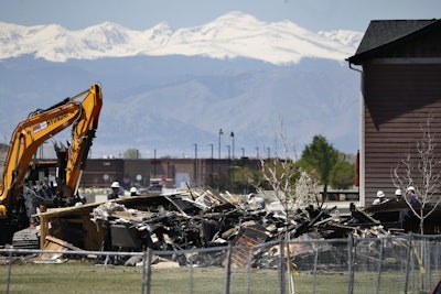 In this May 4, 2017, file photo, workers dismantle the charred remains of a house destroyed by an explosion triggered by natural gas in Firestone, Colo. The April 17, blast killed two people. Investigators blamed the explosion on gas leaking from a severed pipeline that was thought to have been abandoned but was still connected to a well. Colorado Gov. John Hickenlooper said Tuesday, Aug. 22, that the state is tightening regulations on oil and gas pipelines to reduce the chances of another such explosion. (AP Photo/Brennan Linsley, File)