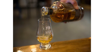 In this Thursday, Aug. 10, 2017 photo, whiskey is poured at the 'Milk and Honey' whiskey distillery in Tel Aviv, Israel. Israel has been known as the land of milk and honey since Biblical times. But could it become known as the land of single malt whiskey? One appropriately named distillery is trying to turn Israel into a whiskey powerhouse. (AP/Sebastian Scheiner)