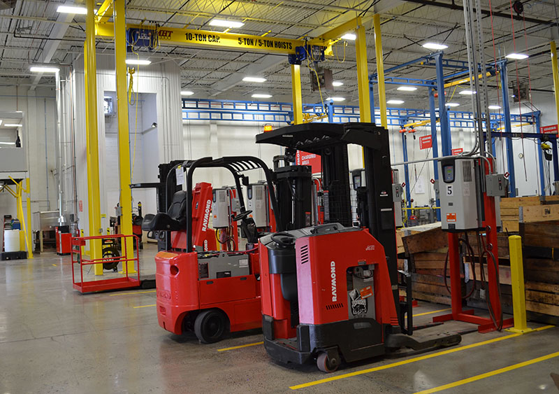 Lift trucks recharge at the Raymond Leasing charging stations. (Raymond Photo)