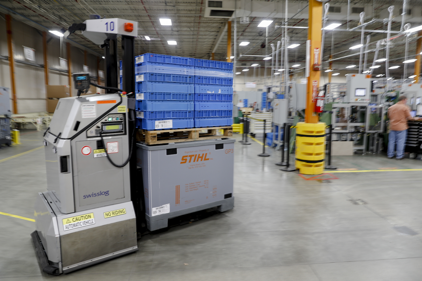 In this Thursday, May 25, 2017 photo, a robotic forklift autonomously transports materials throughout a Stihl Inc. production plant in Virginia Beach, Va. The self-driving forklifts deploy flashing lights and constant beeping sounds to navigate around corners, through doors, and operate safely around their potentially unpredictable human counterparts. (AP Photo/John Minchillo)