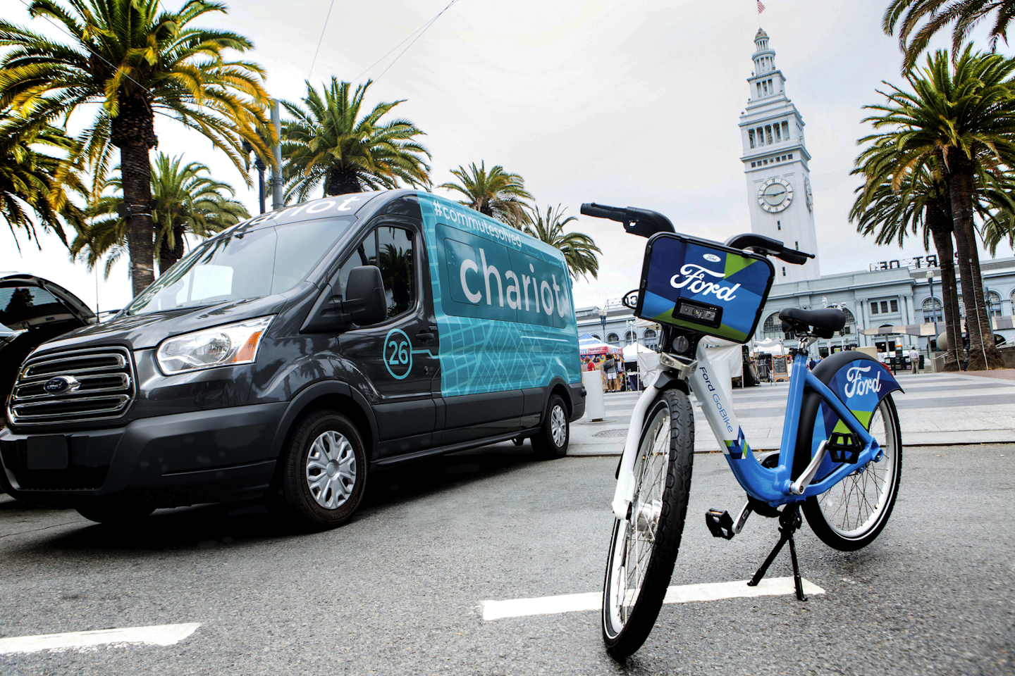 This Thursday, Sept. 8, 2016, file photo taken in San Francisco and provided by Ford Motor Company shows a Ford Transit passenger van operated by Chariot shuttle service and a bicycle operated by bike-share company Motivate. New Ford CEO Jim Hackett says the company isn’t taking its eyes off the present as it prepares for transportation in the future. In September 2016, Ford bought Chariot, an app-based shuttle service that originally operated 100 14-passenger vans in the San Francisco area. Since then it’s tripled the fleet and expanded to New York, Seattle and Austin, Texas. The company also is spending $1 billion to buy a budding robotics startup, Argo AI, to acquire more expertise for autonomous vehicles. (Tommy Lau/Ford Motor Co. via AP, File)