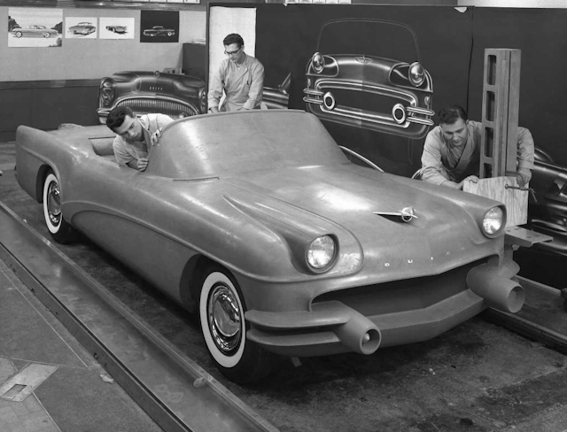 This 1954 photo Courtesy of General Motors shows Buick Design Studio creative clay sculptors as they mold the clay on a model GM automobile. (Courtesy of General Motors via AP)