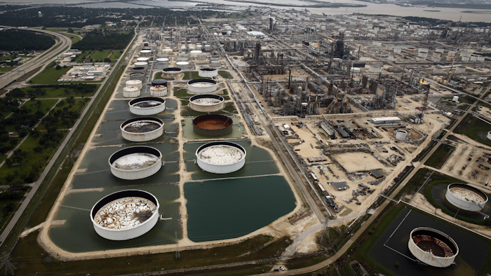 In this Wednesday, Aug. 30, 2017 file photo, large storage tanks situated in retention ponds are surrounded by rainwater left behind by Tropical Storm Harvey at ExxonMobil's refinery in Baytown, Texas. (Tom Fox/The Dallas Morning News via AP, file)