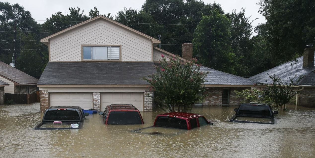 Trucks submerged on Pine Cliff Drive in Houston during heavy rainfall from Harvey (AP photo)